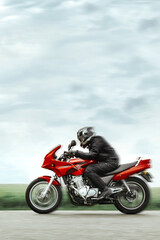 Motorcyclist in protective clothing quickly rides a sports motorcycle