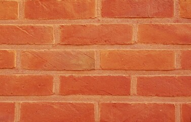 Red brick wall. Background with red stones and red joints.