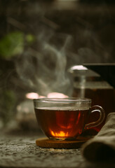 Hot black tea on a dark background 