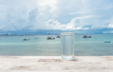 clean and pure drinking, the glass placed on the sea background. healthy drinking glass.