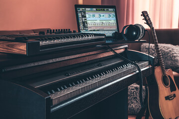 Electronic piano and guitar in room interior.