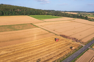 Bird's-eye view of a combine harvester harvesting grain in Taunus/Germany