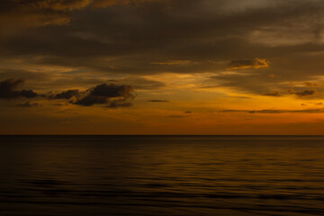 Fototapeta na wymiar Beautiful sunset background at the beach motion blur.
