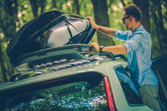 Men Opening Car Roof Rack in Forest