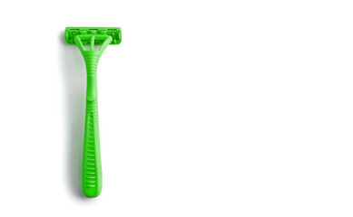 Green women's razor on a white horizontal background with free space for text. Plastic razor on an isolated white background. The concept of smooth skin care and fighting hair in an unnecessary place