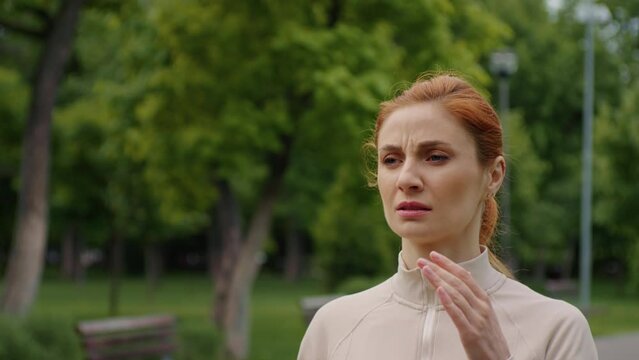 Female having a headache while jogging. Woman stops running because a head pain. Severe migraine concept. Emotions of strong suffering. Pills prescription, fitness training health problems.