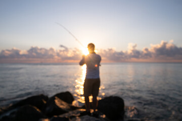 Fototapeta na wymiar Fisherman catches morning rays