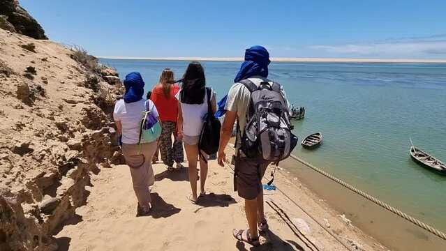 A group of people walking on a tour to the Nayla Lagoon in Morocco