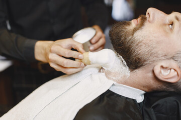 Stylish man sitting in a barbershop