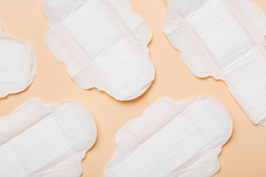 Women hygiene products or sanitary pad on colored background. Pastel color. Closeup. Empty place for text. Female daily hygiene