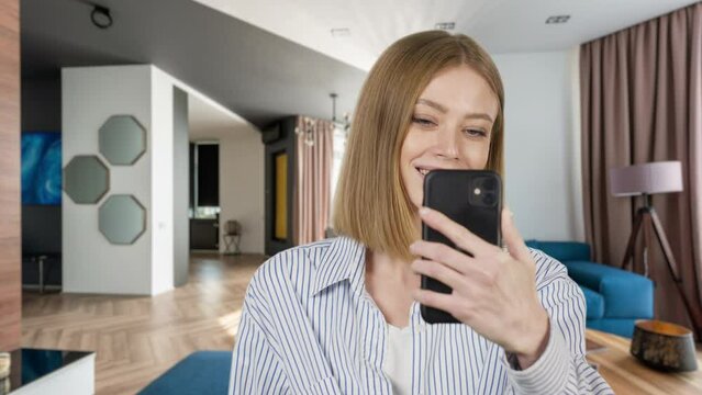 Close-uo of young woman speaking on video call, vlogger using smartphone talking at camera webcam online, selfie call, record lifestyle vlog, blogger online streaming at home 