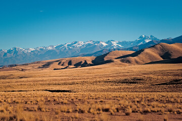 Fototapeta na wymiar Arid grassy steppe by the Andes Mountains near Tupungato, province of Mendoza, Argentina.