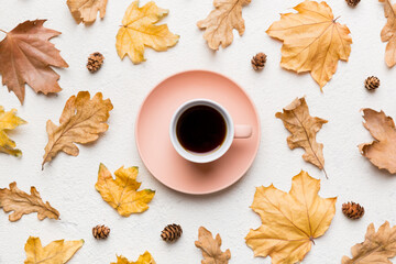 Naklejka na ściany i meble Flat lay composition with colorful Autumn cup of coffee and leaves on a color background. top view