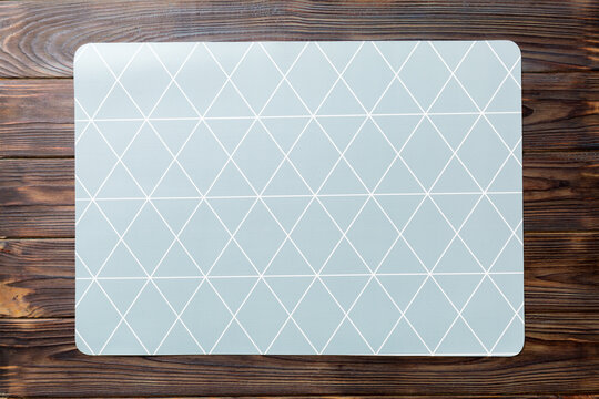 Top view of grey tablecloth for food on wooden background. Empty space for your design