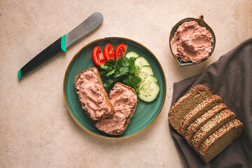 Liver meat pate spread on rye bread, breakfast, close-up, beige background. no people, selective...