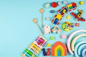 Baby kids toys on light blue background. Colorful educational wooden and musical toys. Top view, flat lay