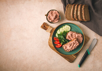Liver meat pate spread on rye bread, breakfast, close-up, beige background. no people, selective focus,