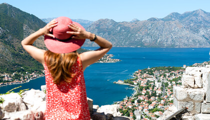 Top view of a beautiful bay, mountains and old town Kotor from Lovcen Mountain. In blur girl...