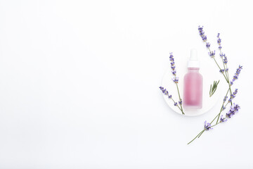 Composition with lavender flowers and natural cosmetic on white background, top view, space for text