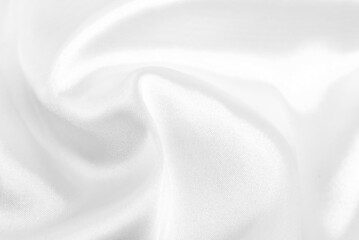 A twisted piece of white fabric. White material or texture with waves and folds. Wrinkled white fabric