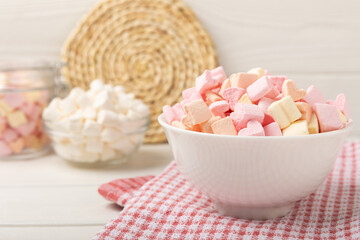 Marshmallow in a glass bowl on a white texture background.Rustic style.Gummous candy close-up.Snacks and snacks for parties.Spice for coffee and cocoa.Winter food concept.Place for text.Place for copy