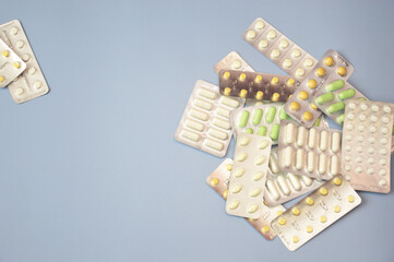 Various medicine tablets in the form of tablets and capsules. Pharmacy, medicine, treatment, prescription. Free space for text.