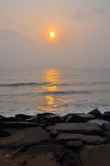 Huge stones on the ocean during a beautiful sunrise, Pondicherry, Tamil Nadu, India	
