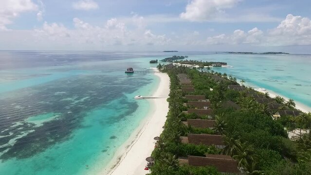 Drone flying above a full of villas in the jungle Maldives island Full HD