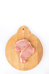 Fresh meat in row with spices on kitchen cutting board. Fillet steak beef meat.