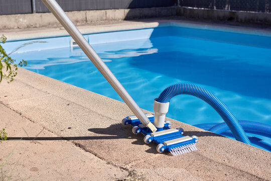 Horizontal frame. Private pool with a pool cleaner on the curb