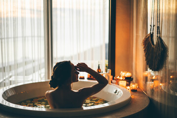 Beautiful woman relaxing at spa. Young lady relaxing in jacuzzi.