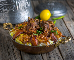 Spicy mutton biryani served in dish side view on wooden table background