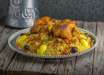 Chicken Machboos biryani served in dish side view on wooden table background
