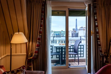 Fototapeten Cosy Paris hotel room with balcony and beautiful view at Eiffel tower and city © Tetiana Soares
