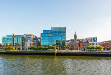 River Liffey waterfront and Church of the Immaculate Heart of Mary in Dublin, Ireland - obrazy, fototapety, plakaty