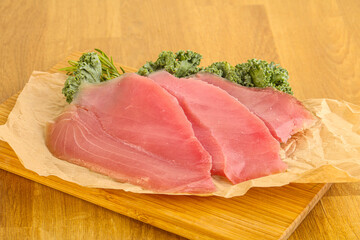Raw salted tuna slice over board