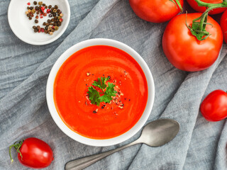 Bowl of tomato soup with parsley top view