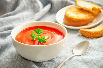 Close up bowl of tomato soup and toasted bread
