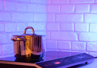 Metal Pot on induction hob in modern kitchen