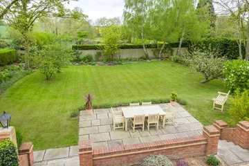 Gordijnen Large landscaped back garden with patio furniture, UK © Paul Maguire