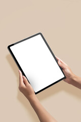 Mockup of new version tablet in trendy thin frame design with white screen with hands on solid...
