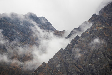 Rocky Mountain top with most clouds and fog on a rainy day in Caucasus national park. Caucasus nature reserve.