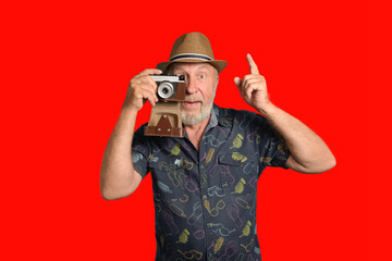 Elderly tourist - photographer. Positive man with a camera