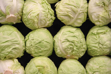 Fototapeta na wymiar Fresh organic white cabbage at a farmers market stand