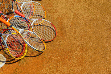 several tennis rackets lie on the tennis court