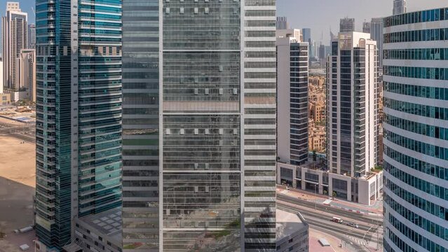 Cityscape skyscrapers of Dubai Business Bay with downtown aerial timelapse. Modern skyline with towers and shadows moving fast. A center of international business