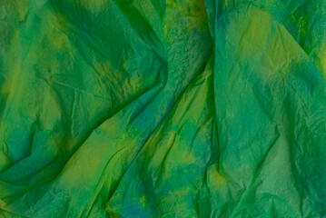 green abstract artistic wallpaper. Wrinkled paper texture.
