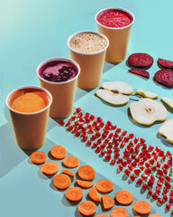 fresh  juices from carrot, pomegranate, beetroot and apple with fruits and vegetables . concept on blue background. isolate. Take away