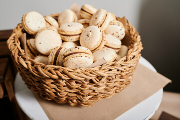 macarons on a plate, cookies on a tray, a cake in a basket, a treat on the festive table of the event