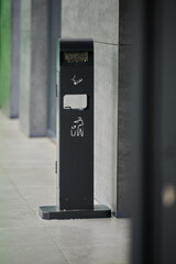 trash can and ashtray for cigarette butts with information signs